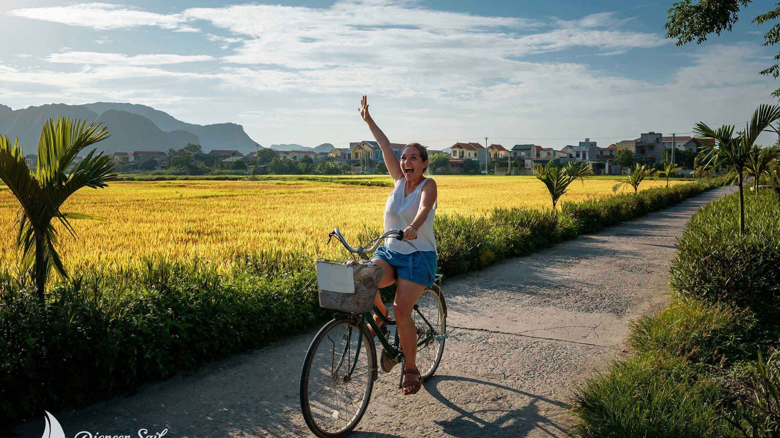 Tourist on bicycle in Ninh Binh Vietnam. Happy woman on her bike