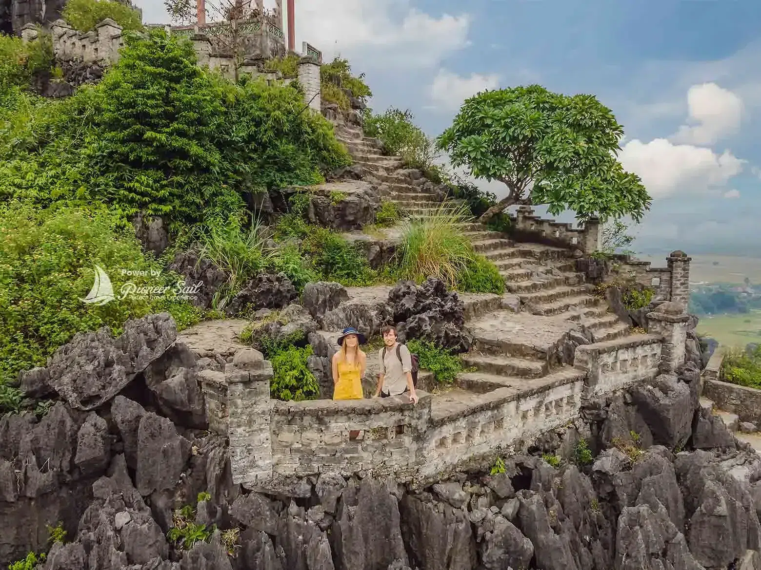 Man And Woman Tourists On Top Pagoda Of Hang Mua Temple Near Tam Coc